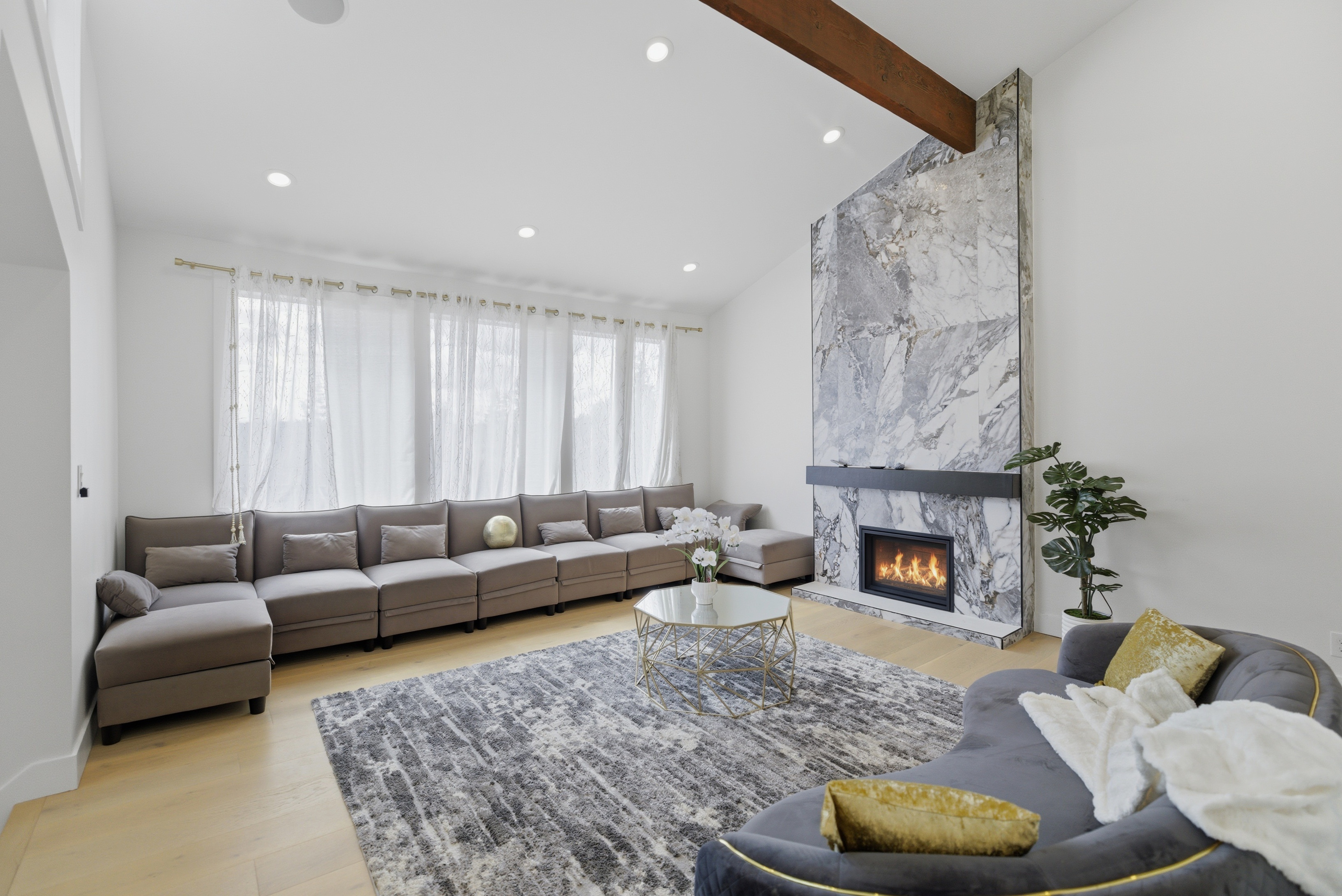 Open-concept living room with soaring ceilings and large windows